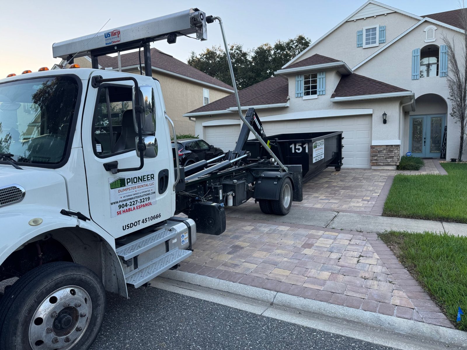 pioneer-dumpster-in-driveway Pioneer roll-off dumpster delivered to a driveway